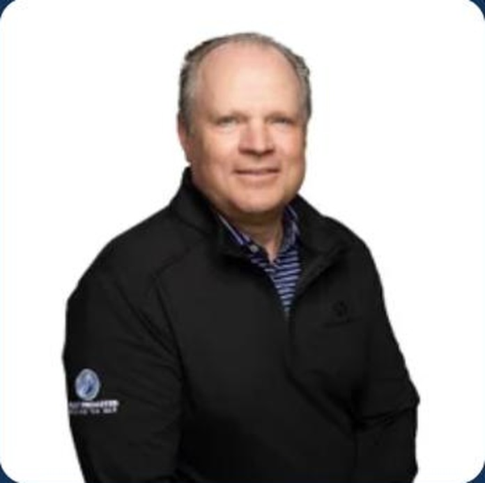 Jeff Cuny, Fully Promoted team member, wearing a custom embroidered branded quarter-zip jacket